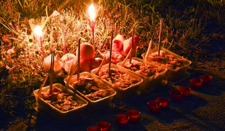 Traditional offerings for the Hungry Ghost Festival, showcasing joss sticks and food offerings.